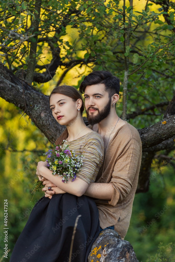 couple hugging near a tree in the park couple hugging near a tree in the park