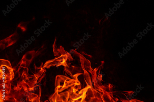 Abstract flame, fire flame texture, background. Blurred moving tongues of fire on a dark background.