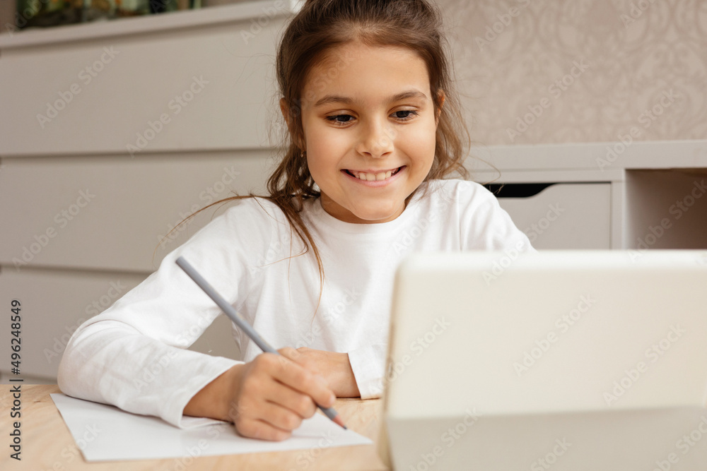 The girl is sitting at the table and is undergoing online trening. The girl is sitting at the table and is undergoing online trening.