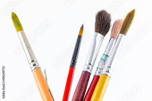 Close focus on paintbrushes on white background.