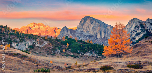 Panoramic autumn view from top of Falzarego pass with Lagazuoi Piccolo peak on background. Nice morning scene Dolomite Alps, Cortina d'Ampezzo lacattion, Italy. Beauty of nature concept background.