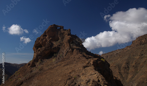 Gran Canaria, landscape of the southern part of the island along Barranco de Arguineguín steep and deep ravine with vertical rock walls, circular hiking route visiting Elephant rock arch 