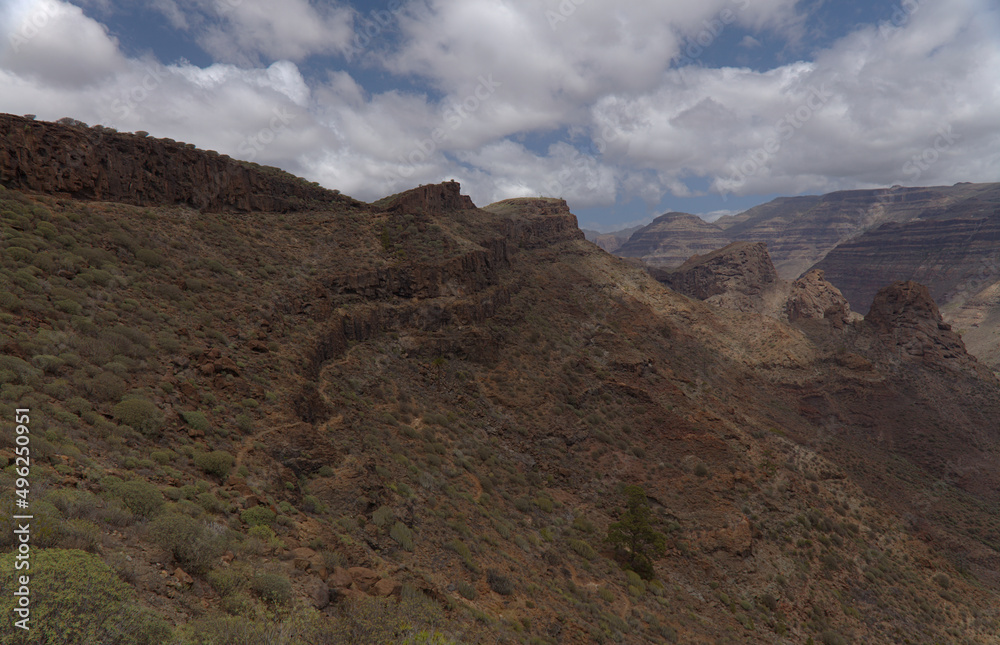 Gran Canaria, landscape of the southern part of the island along Barranco de Arguineguín steep and deep ravine
with vertical rock walls, circular hiking route visiting Elephant rock arch 