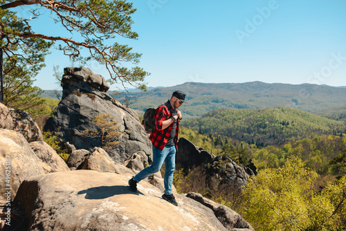 man hiker with backpack at dovbush rocks