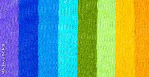 multi colored background. knitted wool fabric texture with stripes © dashtik