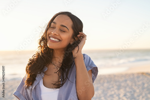 Carefree beautiful latin woman relaxing on beach photo