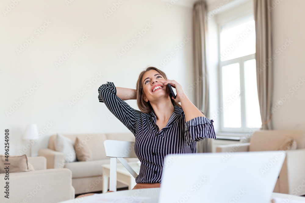 Young Office Woman Talking to Someone on her Mobile Phone While Looking Into the Distance with Happy Facial Expression. Young Office Woman Talking to Someone on her Mobile Phone While Looking Into the Distance with Happy Facial Expression.