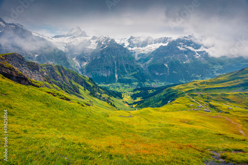 Wonderful summer view from the top of Grindelwald First cableway. Schreckhorn summit in the morning mist  Grindelwald village location  Swiss Bernese Alps  Switzerland  Europe.