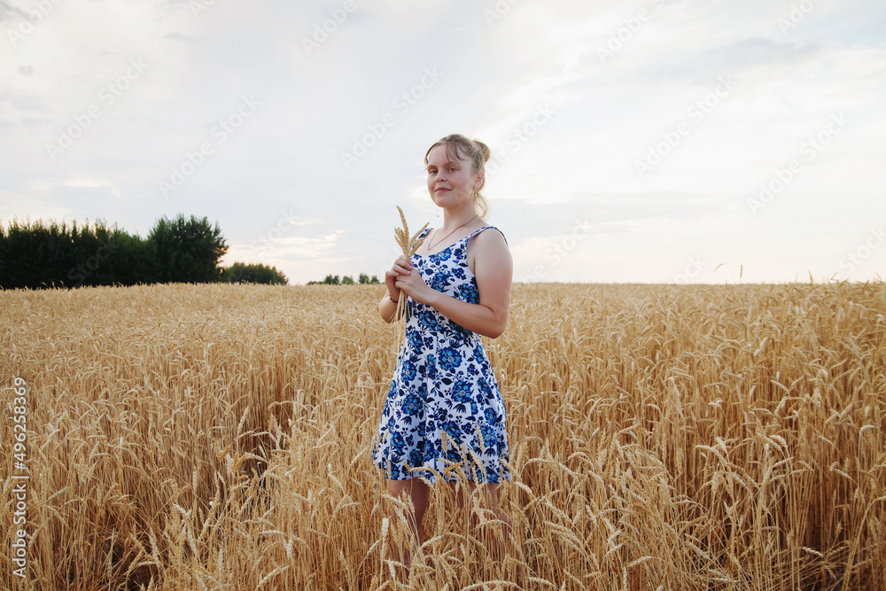 Teen girl dress on walk in field in summer Teen girl dress on walk in field in summer