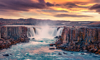 Extraordinary summer view of Selfoss Waterfall. Rocky coast of Jokulsa a Fjollum river, Jokulsargljufur National Park. Great sunrise in Iceland, Europe. Beauty of nature concept background..