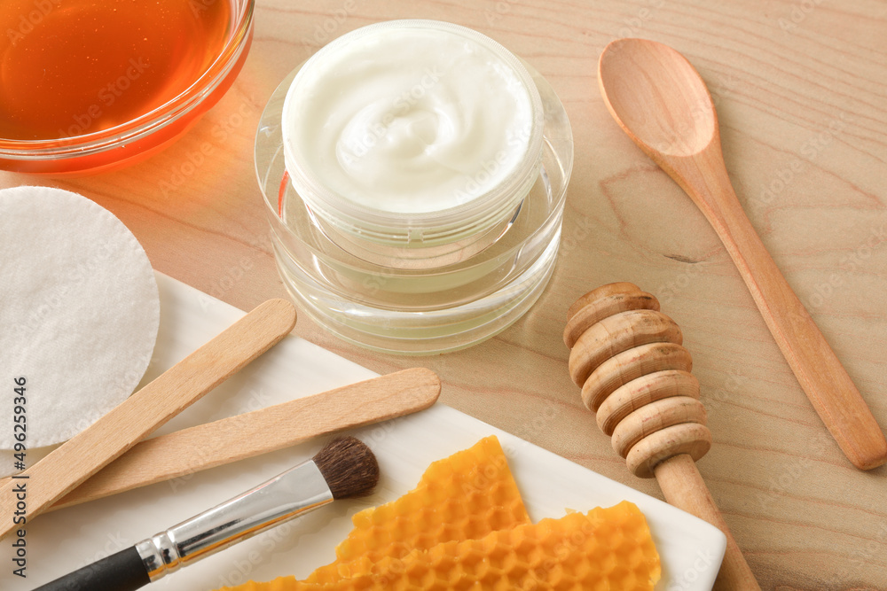 Moisturizing skin care cream with honey extracts on table detail