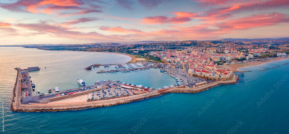 Colorful morning cityscape of Termoli port. Panoramic summer view of Sant'Antonio beach. Majrstic sunrise on Adriatic sea. Traveling concept background.
