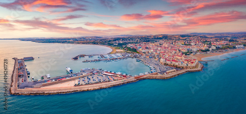 Colorful morning cityscape of Termoli port. Panoramic summer view of Sant'Antonio beach. Majrstic sunrise on Adriatic sea. Traveling concept background.