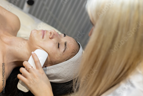 Cosmetic facial skin care procedure in the cosmetologist's office for a woman