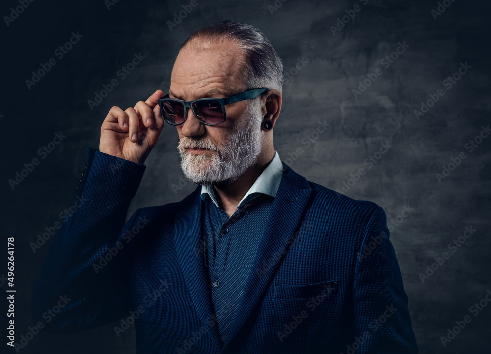 Fashionable old man with sunglasses dressed in dark blue jacket Fashionable old man with sunglasses dressed in dark blue jacket