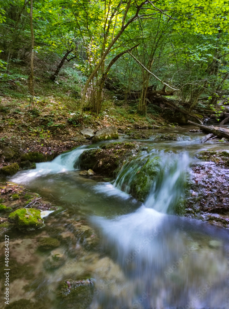 beautiful waterfall in the mountain gorge