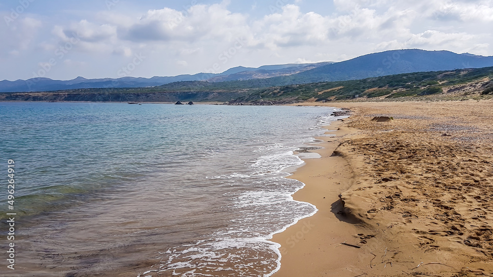 Panoramic view on Lara Beach, Cyprus from above. Hidden gem, not spoiled by tourists. Solitude, calm feelings, waves gently spreading on the beach. turquoise color of the water. Turtle hatching beach