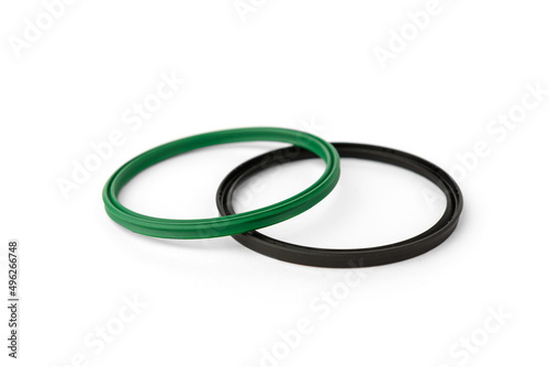 Green and black rubber gasket ring isolated on white background.