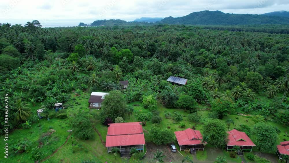 Aerial view over a resort and the Inhame beach, in cloudy Sao Tome, Africa - reverse, drone shot Aerial view over a resort and the Inhame beach, in cloudy Sao Tome, Africa - reverse, drone shot
