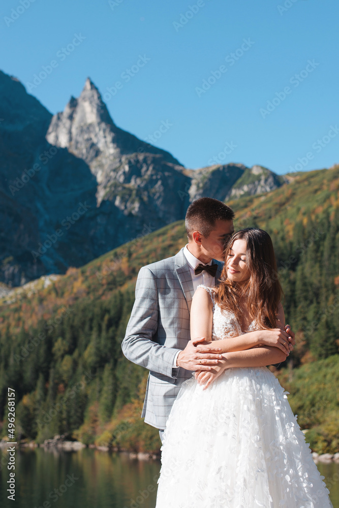 Young wedding couple near lake in Tatra mountains, Poland