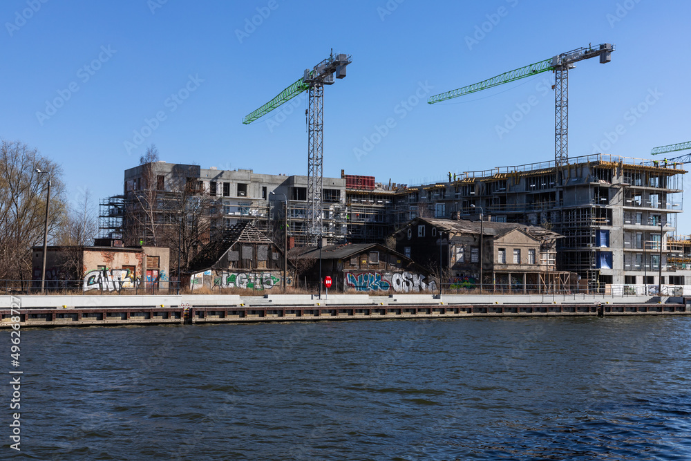Old, damaged houses during the construction of new houses on the banks of the Motława River in Gdańsk Old, damaged houses during the construction of new houses on the banks of the Motława River in Gdańsk