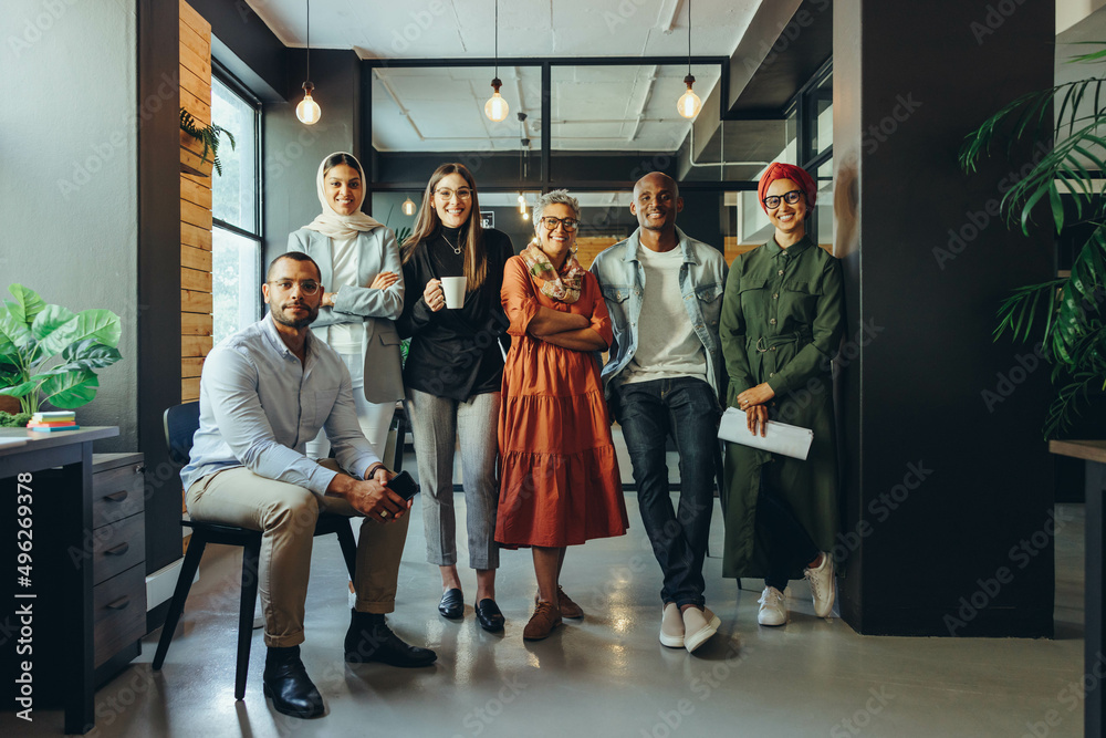 Fototapeta premium Diverse business team smiling at the camera in an office