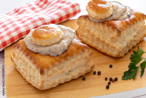 puff pastry garnished with veal rice on wooden board