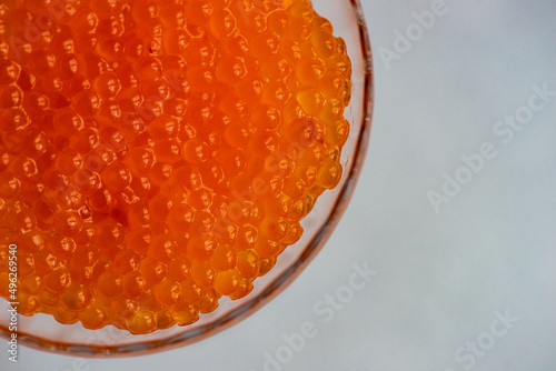 Close-up overhead view of red trout caviar in a glass dessert coupe photo