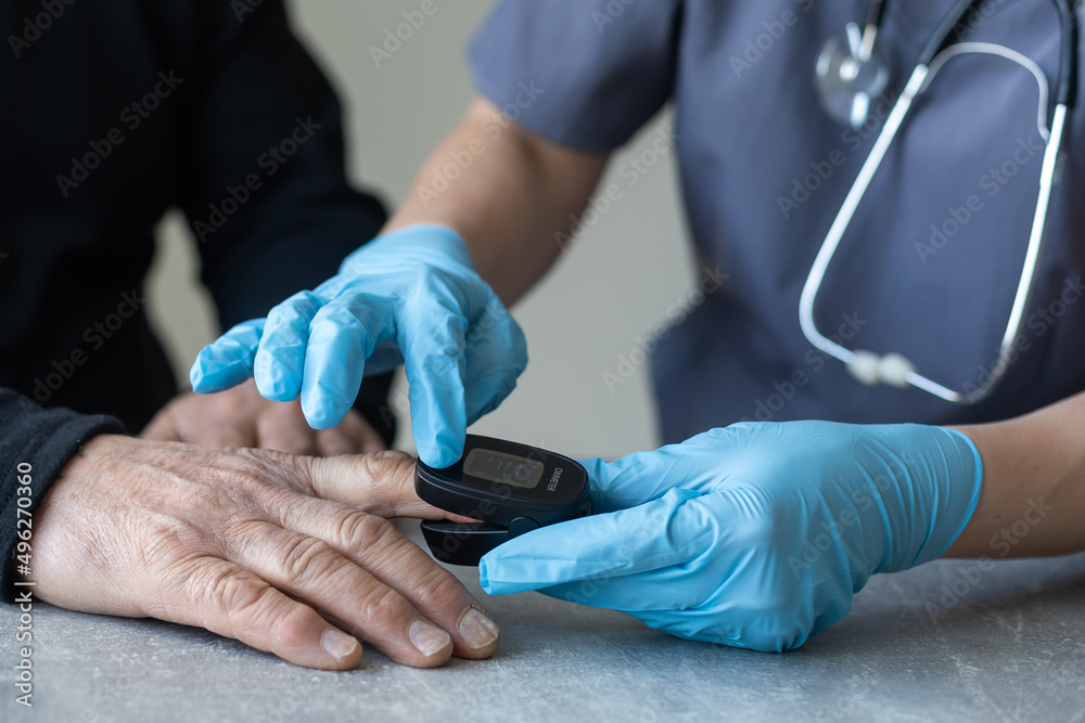 elderly man and nurse measuring pulse oximeter