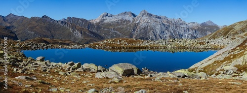 The Swiss Alps seen from the Bergseeli: a small high-altitude alpine lake on the border between Switzerland and Italy, near the Spluga Pass - September 2021