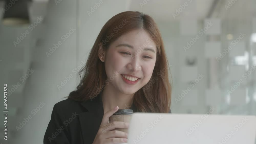 Happy young business woman wearing headphones, Talking and video calling on laptop. Smiling and happy. Soft focus. Happy young business woman wearing headphones, Talking and video calling on laptop. Smiling and happy. Soft focus.