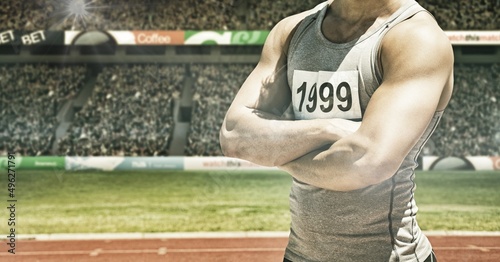 Spots of light against mid section of male athlete with arms crossed against sports stadium © vectorfusionart