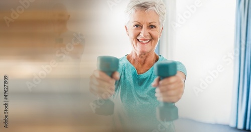 Blur effect with copy space against portrait of caucasian senior woman working out with dumbbells
