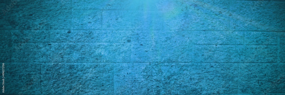 Spots of light over blue brick wall background with copy space Spots of light over blue brick wall background with copy space