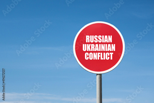 'Russian Ukrainian Conflict' sign in red frame. Blue sky is on background