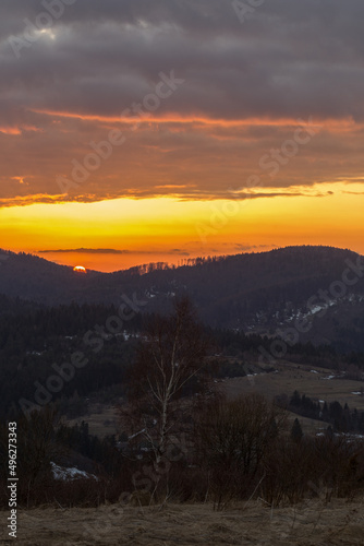 An evening with a blazing sky in the Carpathian Mountains. Landscape of the Carpathian mountains with a blazing evening sky on the horizon.