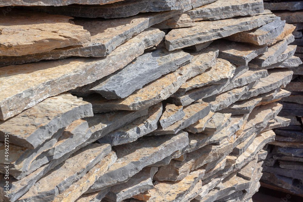Stacked natural stone slabs in brown colors. Flagstone. Stacked natural stone slabs in brown colors. Flagstone.