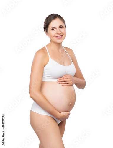Young pregnant woman in swimsuit. Girl expecting a baby and touching her belly isolated on white background.