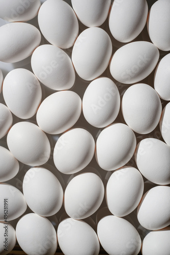 White eggs background. White eggs in a row. Shallow depth of field
