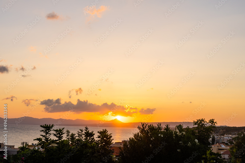 Beautiful sunset over the sea with a view at palms on the beach Beautiful sunset over the sea with a view at palms on the beach