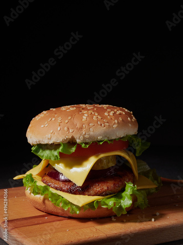 fresh delicious burger on a black background