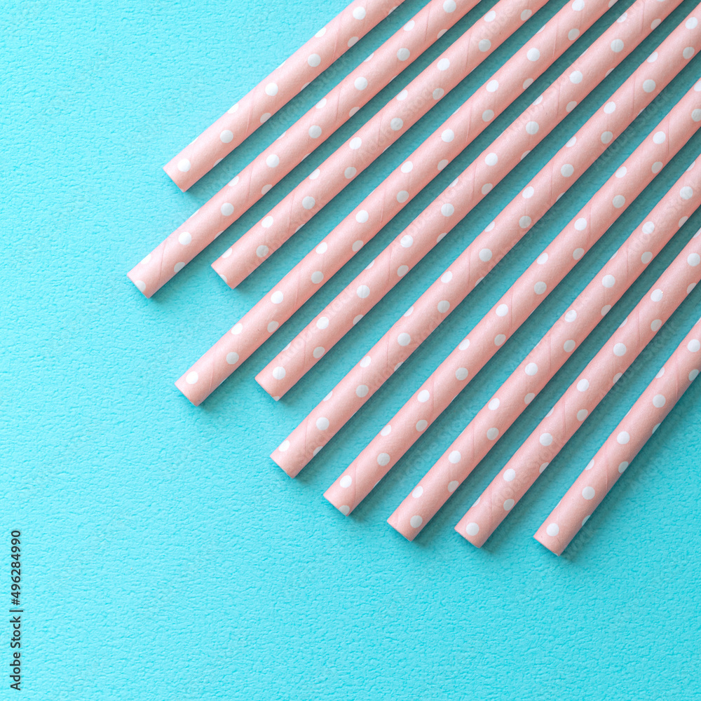 Biodegradable paper straw set on blue table background. Biodegradable paper straw set on blue table background.