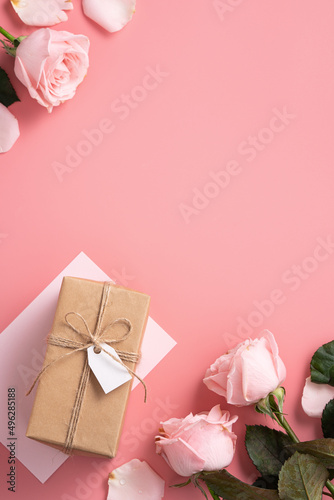 Mother's Day design concept background with pink rose flower and gift on pink background.