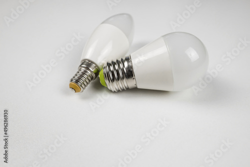 two energy efficient light bulbs on white.