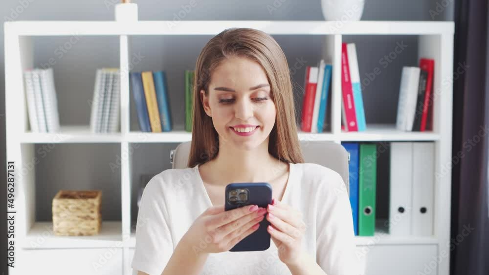 Young Woman Works at Home Office Using Computer and Smertphone. Workplace of Female Entrepreneur, Freelancer or Student. Remote Work and Education Concept. Young Woman Works at Home Office Using Computer and Smertphone. Workplace of Female Entrepreneur, Freelancer or Student. Remote Work and Education Concept.