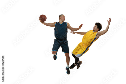 Top view of two young basketball players training with ball isolated on white studio background. Motion, activity, sport concepts.