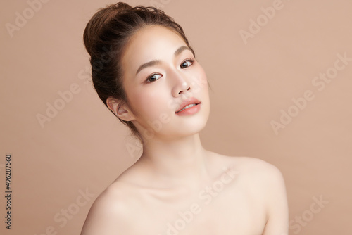 Beautiful young asian woman with clean fresh skin on beige background, Face care, Facial treatment, Cosmetology, beauty and spa, Asian women portrait.