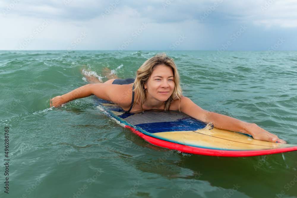 Close-up portrait young adult slim sporty female surfer girl enjoy swimming with surfboard ocean coast wave clear water on sunny day . Sport healthy carefree freedom lifestyle vacation concept