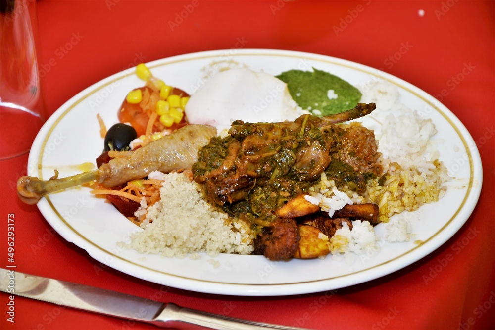 Un plat de riz avec  la viande  de  poulet  une spécialté africaine .