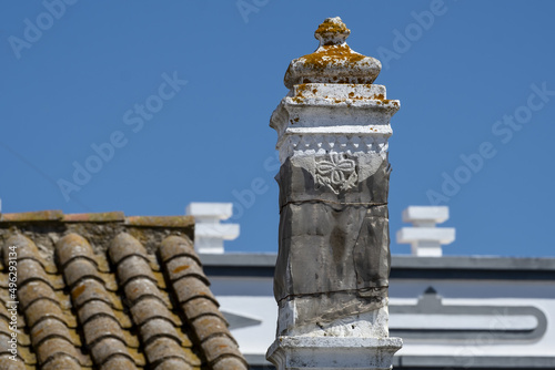Close view of a traditional algarvian chimney on the roof of a house in the old town of Tavira, Algarve, Portugal